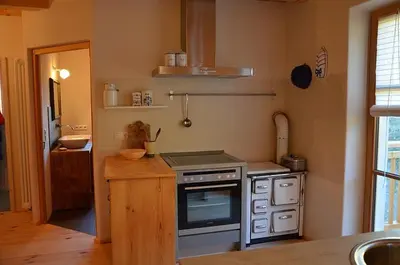 a kitchen with a stove and a counter top at Kinighof 5 in Soprabolzano