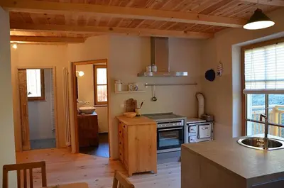 a kitchen with a stove and a counter top at Kinighof 5 in Soprabolzano