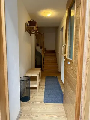 a hallway with a staircase with a stair case at Il Molino nel bosco - PT in Alleghe