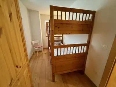 a room with a bunk bed and a ladder at Il Molino nel bosco - PT in Alleghe