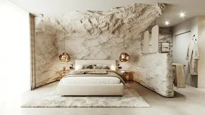 a bedroom with a white bed and a stone wall at My Mountain Moments - Cave Design Hotel in Selva dei Molini
