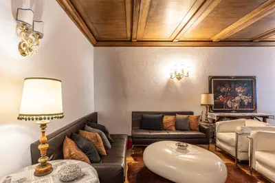 a living room with a couch and a table at Casa Cavallino, in centro a Cortina dAmpezzo in Cortina dʼAmpezzo