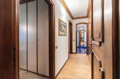 a hallway with white walls and wooden floors at Casa Cavallino, in centro a Cortina dAmpezzo in Cortina dʼAmpezzo