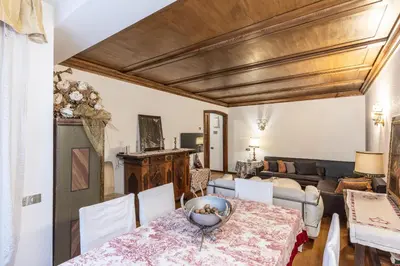 a living room with a table and a couch at Casa Cavallino, in centro a Cortina dAmpezzo in Cortina dʼAmpezzo