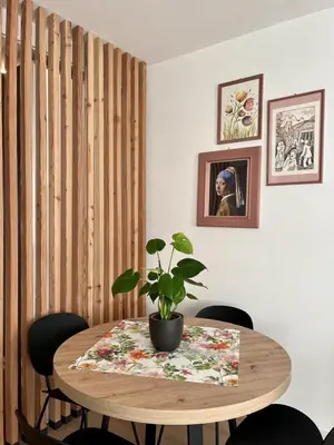 a dining room table with a potted plant on it at The Cozy Peak - 360 Dolomites View in Agordo