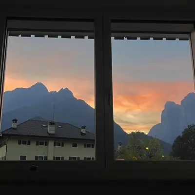 a window with a view of a mountain view at The Cozy Peak - 360 Dolomites View in Agordo