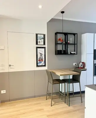 a kitchen and dining room with a table and chairs at The Cozy Peak - 360 Dolomites View in Agordo