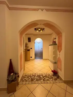 a hallway with an archway and a door in a house at Ciasa Cermis in Cavalese