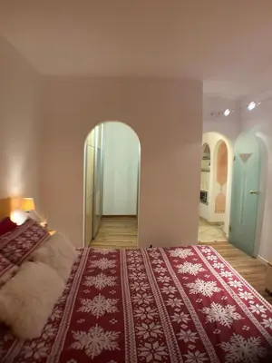 a bedroom with a bed and an arched doorway at Ciasa Cermis in Cavalese