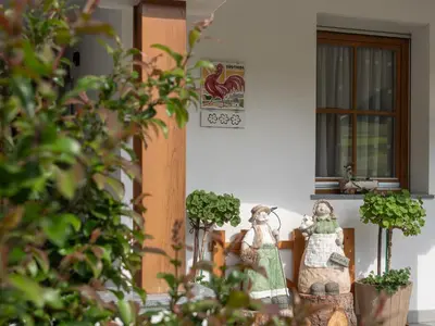 a group of figurines sitting in front of a house at Branterhof in Rasun di Sopra