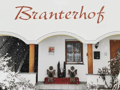 a store front in the snow with a sign on it at Branterhof in Rasun di Sopra