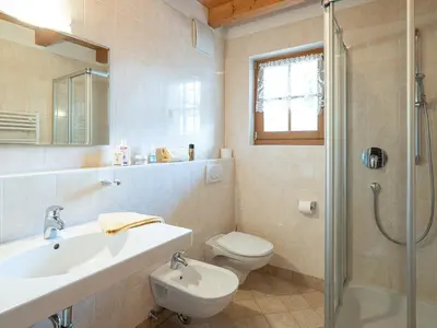 a bathroom with a sink and a toilet and a shower at Branterhof in Rasun di Sopra