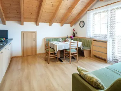 a kitchen and dining room with a table and chairs at Branterhof in Rasun di Sopra