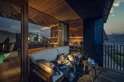 a living room with a couch on a balcony at Sorafurcia Lodge in Sorafurcia