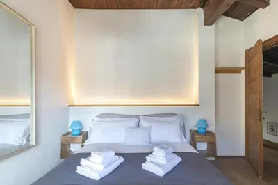 a bedroom with a bed with towels on it at Ciasa Remo 2 by WelcHome in San Vito di Cadore