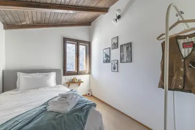 a bedroom with a bed and a window at Ciasa Remo 2 by WelcHome in San Vito di Cadore