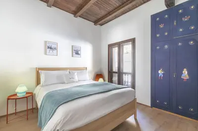 a bedroom with a large bed and blue cabinets at Ciasa Remo 2 by WelcHome in San Vito di Cadore