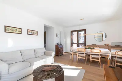 a living room with a white couch and a table at Ciasa Remo 2 by WelcHome in San Vito di Cadore