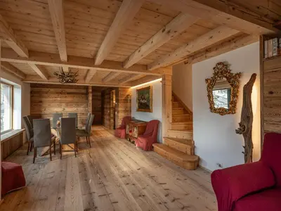 a dining room with a table and chairs at Casa Poligrafica 2, panoramica e super confortevole in Cortina dʼAmpezzo