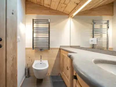 a bathroom with a sink and a toilet in it at Casa Poligrafica 2, panoramica e super confortevole in Cortina dʼAmpezzo