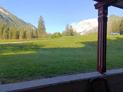 a view from a window of a field of grass at Villaggio Ploner in Dobbiaco