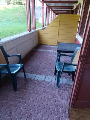 two blue chairs sitting in a train hallway at Villaggio Ploner in Dobbiaco
