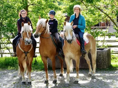 a group of three people riding on horses at Gasthof Greif in Sarntal