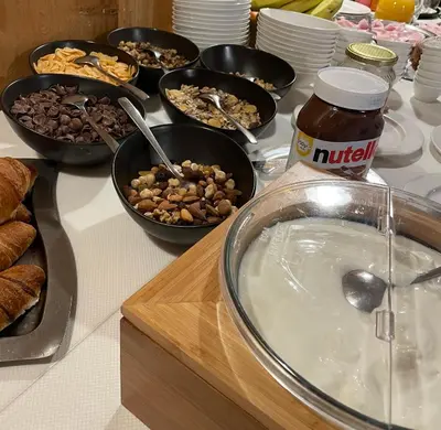 a table topped with bowls of food and other foods at Gasthof Greif in Sarntal