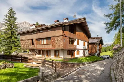 a large wooden house in the mountains at Cozy 3 bedroom with beautiful view and access to garden in Cortina dʼAmpezzo