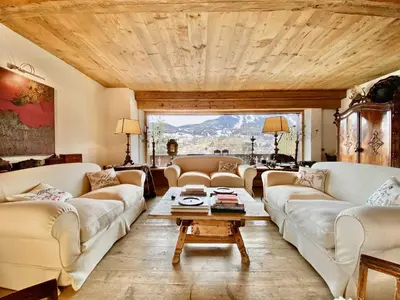 a living room with couches and a table at Luxury flat with views - few steps from centre in Cortina dʼAmpezzo