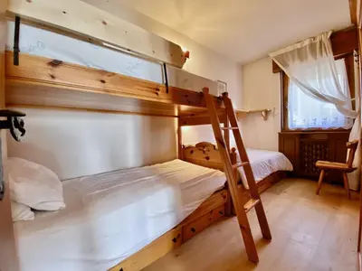 a bedroom with two bunk beds and a ladder at Cozy 3 bedroom in amazing location in Cortina dʼAmpezzo