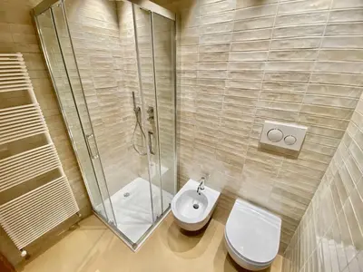 a bathroom with a shower and a toilet and a sink at Cozy 3 bedroom in amazing location in Cortina dʼAmpezzo