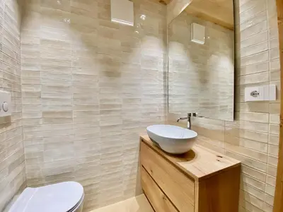 a bathroom with a sink and a toilet at Cozy 3 bedroom in amazing location in Cortina dʼAmpezzo