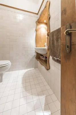 a bathroom with a sink and a toilet at Casa Merisanda, confortevole e immersa nel verde in Cortina dʼAmpezzo