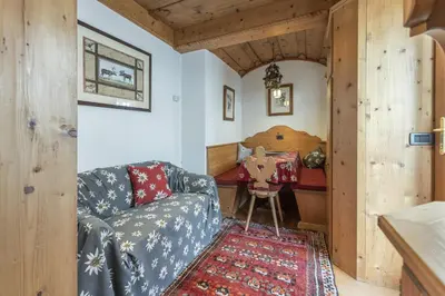 a living room with a couch and a table at Casa Col 3, graziosa e confortevole a due passi dalle piste in Cortina dʼAmpezzo