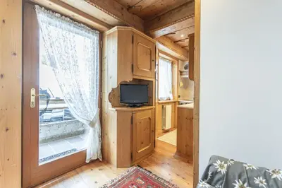 a tiny house with a tv and a window at Casa Col 3, graziosa e confortevole a due passi dalle piste in Cortina dʼAmpezzo