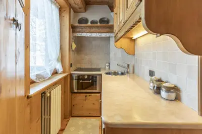 a small kitchen with a sink and a stove at Casa Col 3, graziosa e confortevole a due passi dalle piste in Cortina dʼAmpezzo