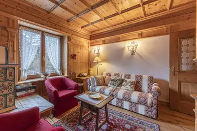 a living room with a couch and a table at Casa Varentin, in the center of Cortina in Cortina dʼAmpezzo