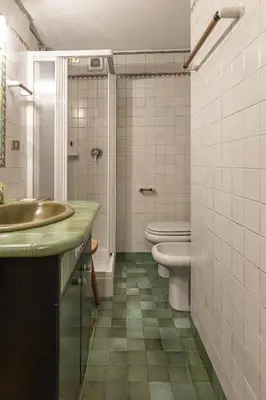 a bathroom with a sink and a toilet at Casa Varentin, in the center of Cortina in Cortina dʼAmpezzo