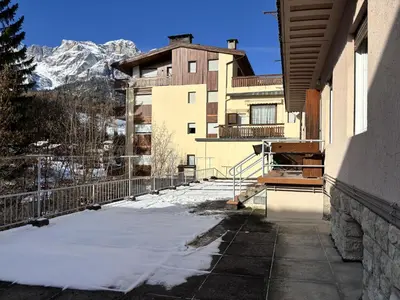 a balcony of a building with snow on the ground at Casa Varentin, in the center of Cortina in Cortina dʼAmpezzo