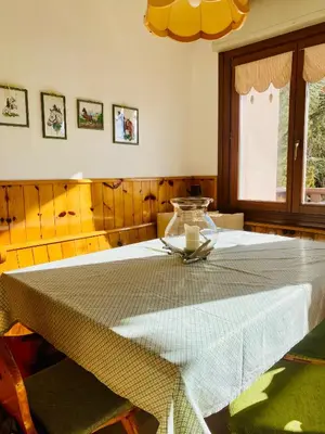a dining room table with a white table cloth on it at Zirmo mountain home in Carano