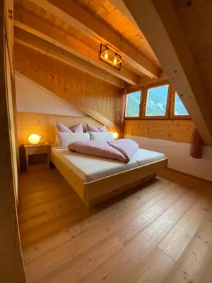 a bedroom with a bed in a attic at dolomites view apartment 2 in Rasun di Sopra
