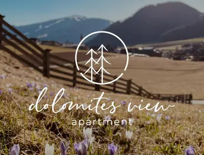 a picture of a field with a fence and flowers at dolomites view apartment 2 in Rasun di Sopra