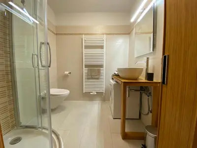 a bathroom with a shower and a toilet and a sink at dolomites view apartment 2 in Rasun di Sopra