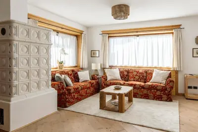 a living room with a couch and a table at Chalet Chiave - Prenotazioni Dirette Dolomiti Skyline in Cortina dʼAmpezzo