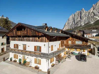 an overhead view of a building with mountains in the background at Chalet Chiave - Prenotazioni Dirette Dolomiti Skyline in Cortina dʼAmpezzo