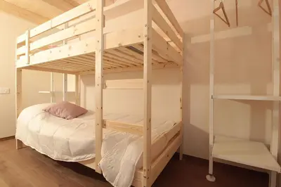 a bunk bed in a room with a bunk bedutenewayangering at Casa Tomà Mountain View Cortina in San Vito di Cadore