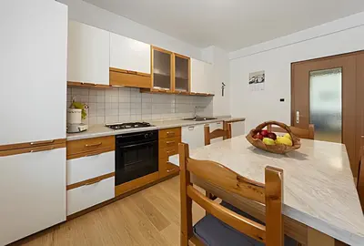 a kitchen with a bowl of fruit on a table at Tai Bedoes in Moena