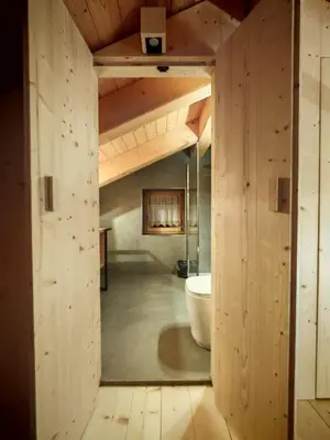 a bathroom with a tub and a toilet in a room at Selva loft in Selva di Cadore