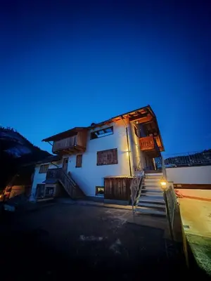 a white building with stairs in front of it at Selva loft in Selva di Cadore